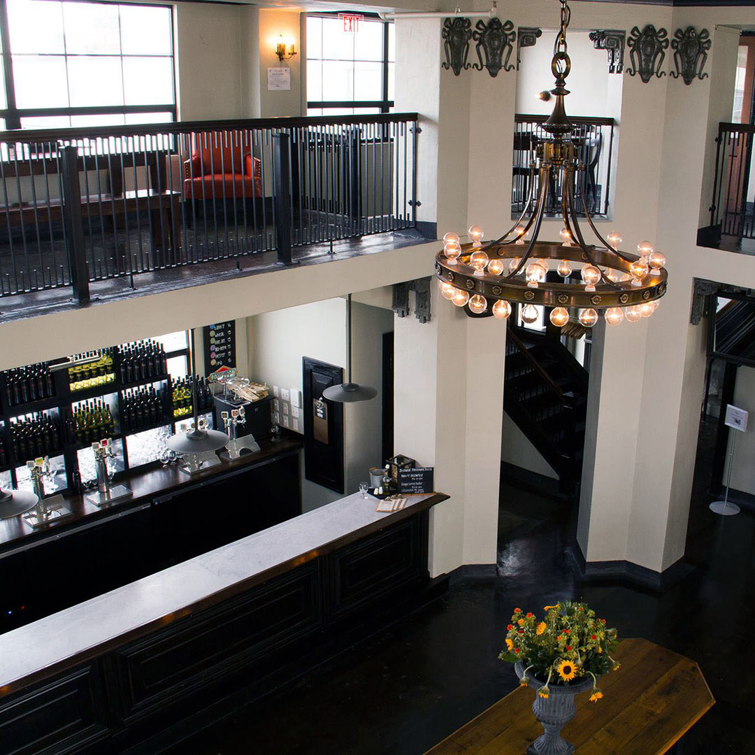 Overhead view of the tasting room at Amigoni Urban Winery with a chandelier and bar area.