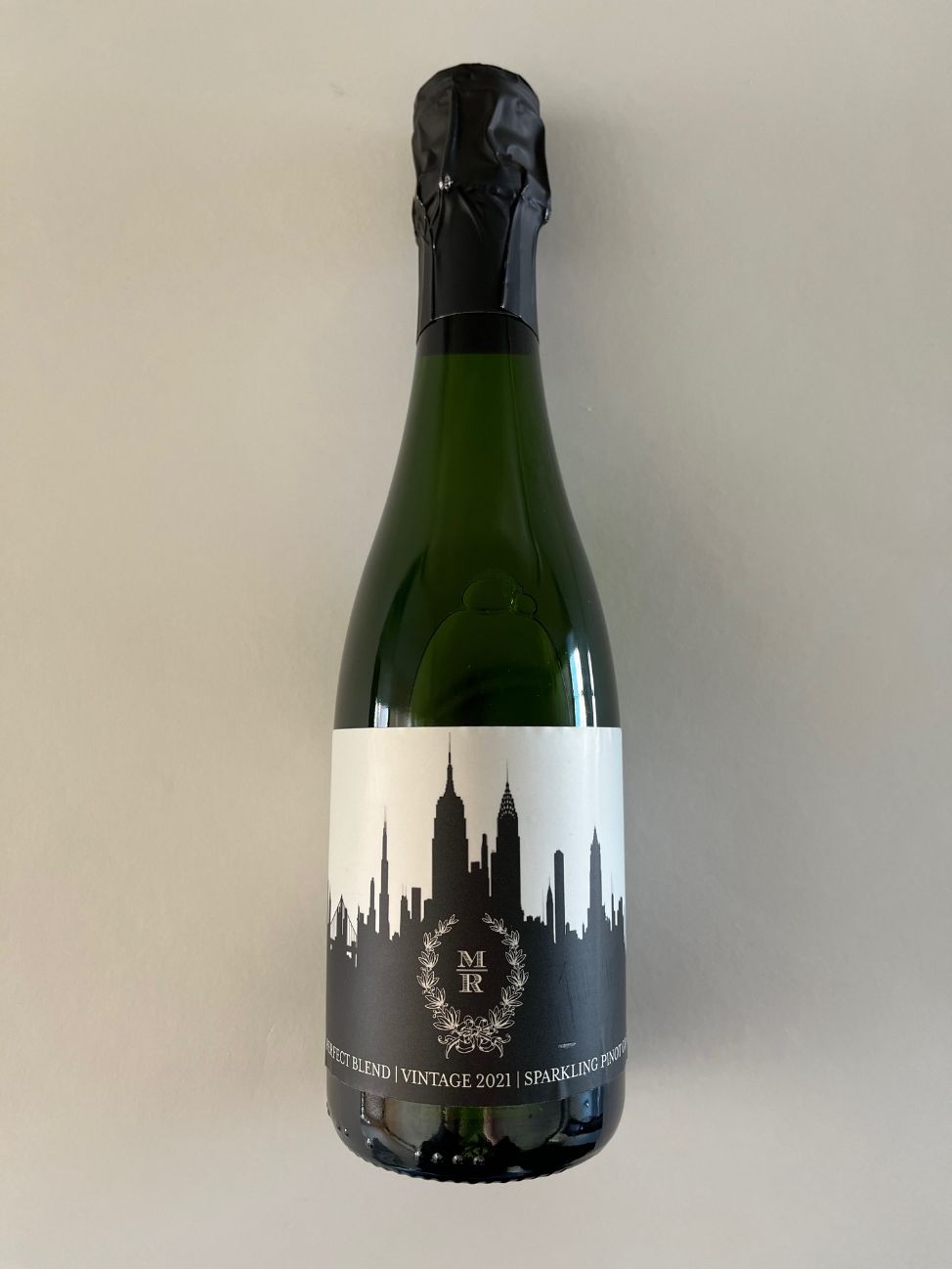 Bottle of sparkling wine with a custom label from Amigoni Urban Winery.