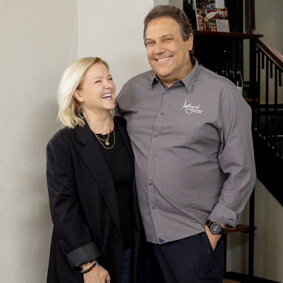 A picture of husband and wife, Kerry and Michael Amigoni, standing and smiling in their winery.