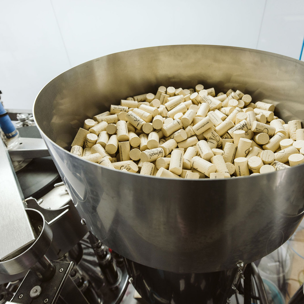 A large metal container filled with wine corks, ready for use in the bottling process at Amigoni's winery.